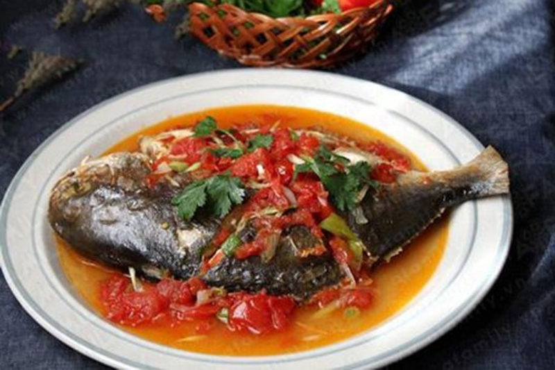 fish topped with tomato sauce